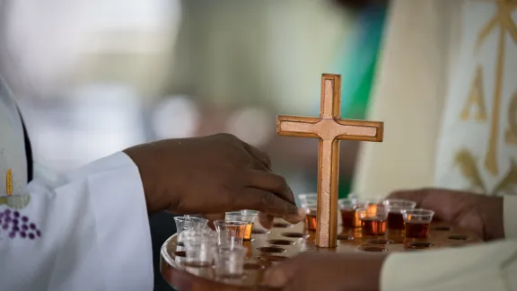 Bread and wine is distributed for holy communion during opening worship.
